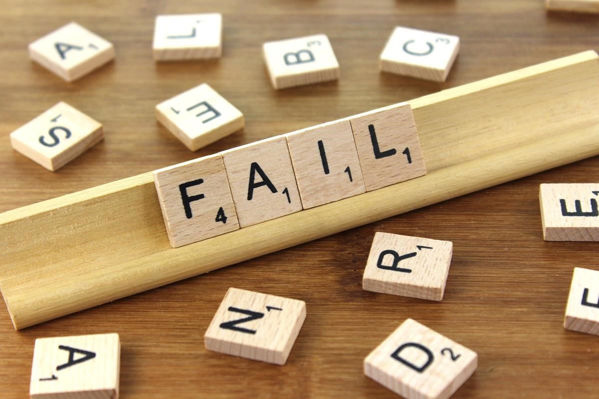 Scrabble pieces on a stand spelling out the word "FAIL".