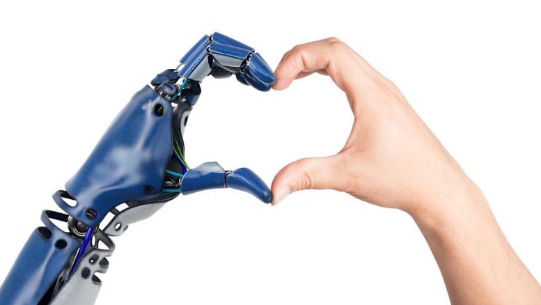 A robotic hand and a human hand forming a heart shape.