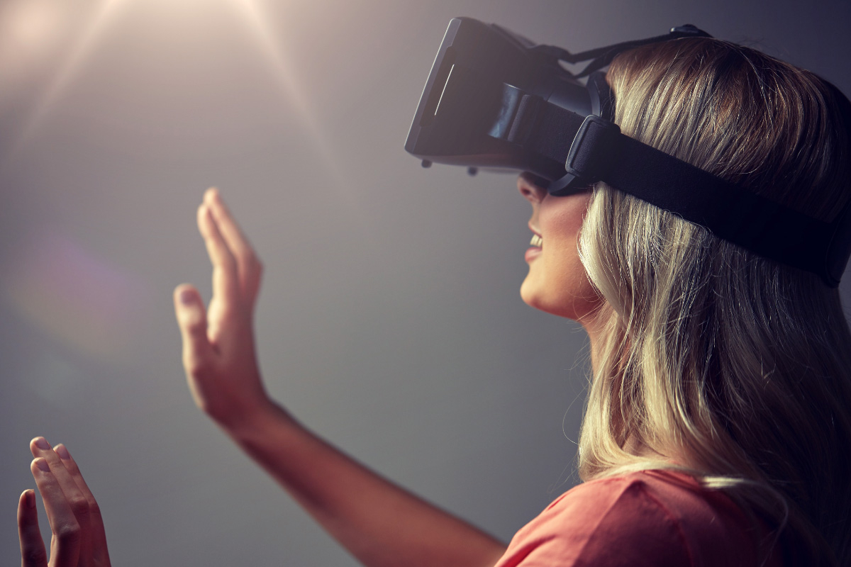 Woman wearing a VR headset and looking into a light source.
