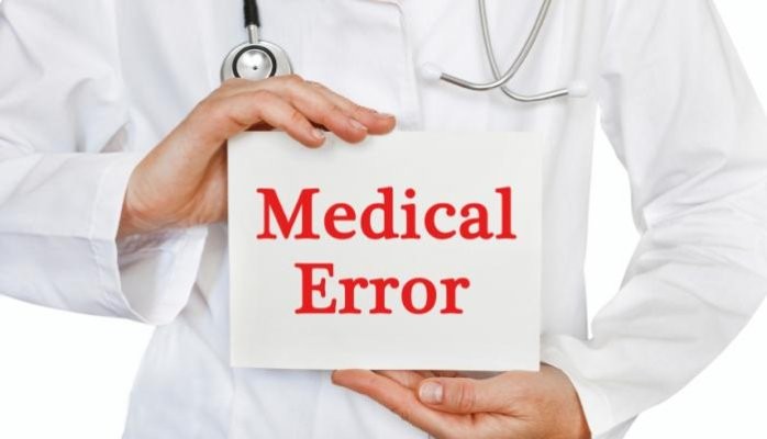 Doctor holding a sign that says - Medical Error