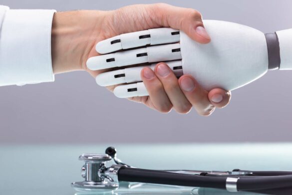A human hand shaking a robotic hand.
