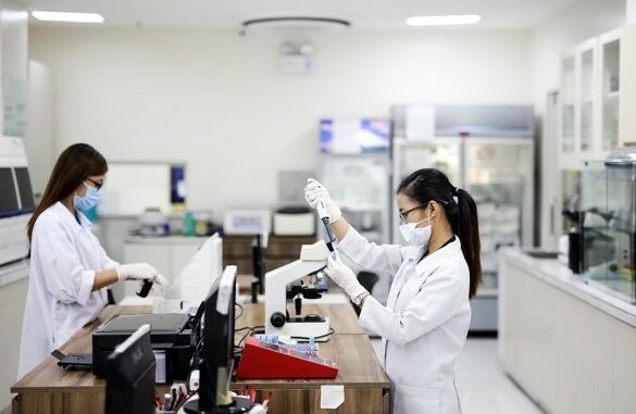Two doctors working with lab equipment.